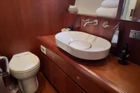 Luxurious bathroom in 2010 Aicon 85 yacht with modern sink and wooden cabinetry.