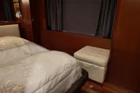 Luxurious bedroom interior of 2010 Aicon 85 yacht with bed and ottoman.