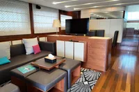Luxurious interior of 2010 Aicon 85 yacht with modern furnishings and wooden flooring.