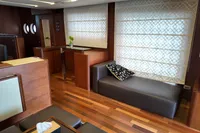 Luxurious interior of 2010 Aicon 85 yacht with modern furnishings and wooden flooring.