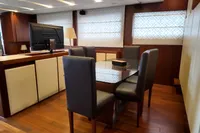 Luxurious interior of 2010 Aicon 85 yacht with elegant dining area and modern decor.