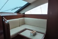 Luxurious interior of 2010 Aicon 85 yacht with cream seating and wooden accents.