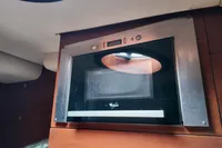 Built-in microwave in Aicon 85 yacht kitchen, 2010 model, with wooden cabinetry.