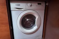 Front-loading washing machine in wooden cabinet, Aicon 85, 2010 model.