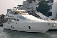 Luxury Aicon 85 yacht from 2010 docked near waterfront buildings.
