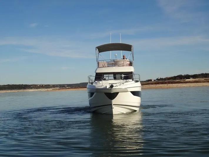  Yacht Photos Pics 2024 Prestige 420F yacht cruising on a calm lake.