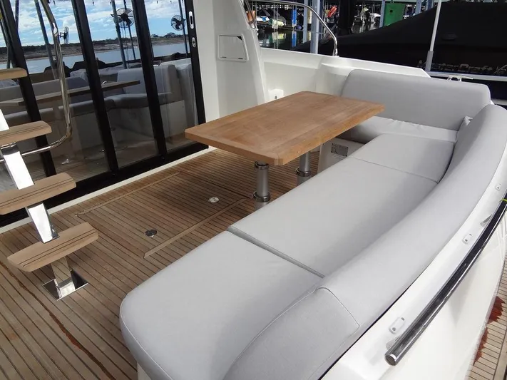  Yacht Photos Pics Prestige 420F 2024 yacht deck with seating area and wooden table.