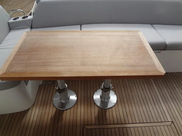  Yacht Photos Pics Prestige 420F 2024 yacht interior with wooden table and cushioned seating.