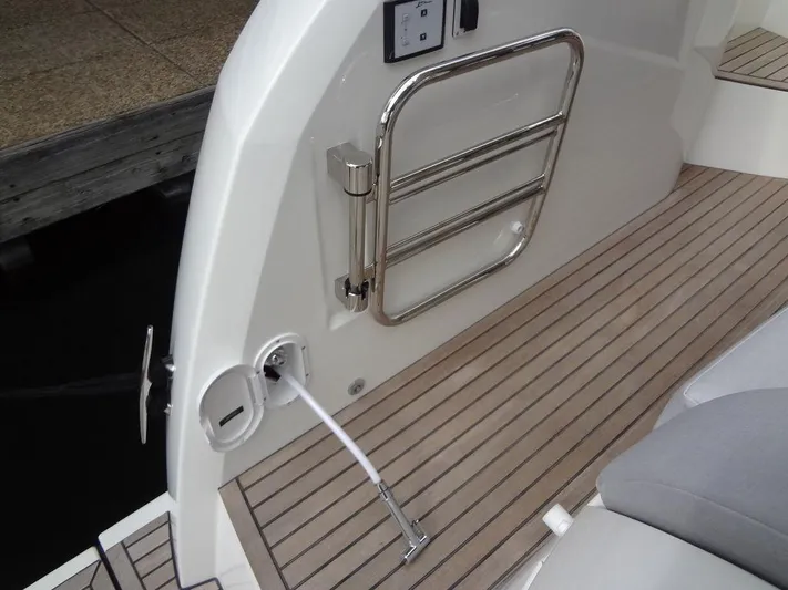  Yacht Photos Pics 2024 Prestige 420F yacht deck with stainless steel ladder and teak flooring.
