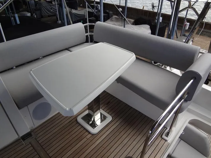  Yacht Photos Pics 2024 Prestige 420F yacht, outdoor seating area with a sleek table and cushioned benches.