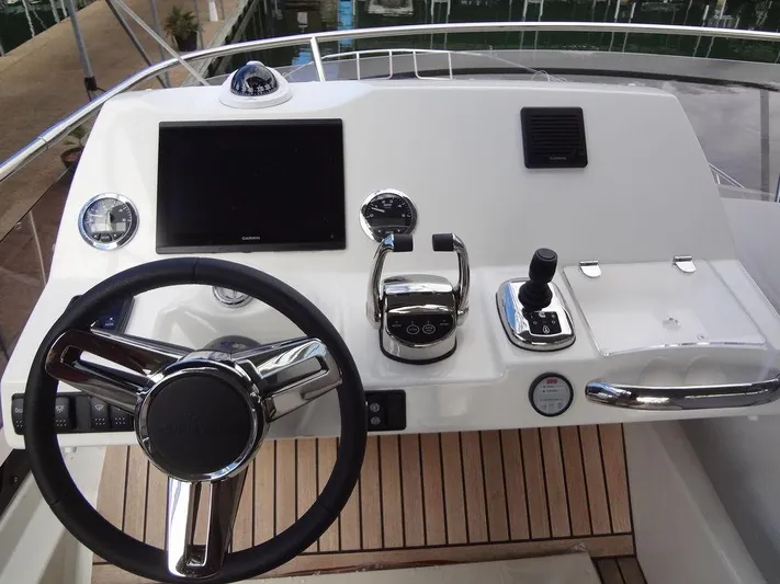 Yacht Photos Pics Prestige 420F 2024 yacht helm station with modern controls and navigation screen.