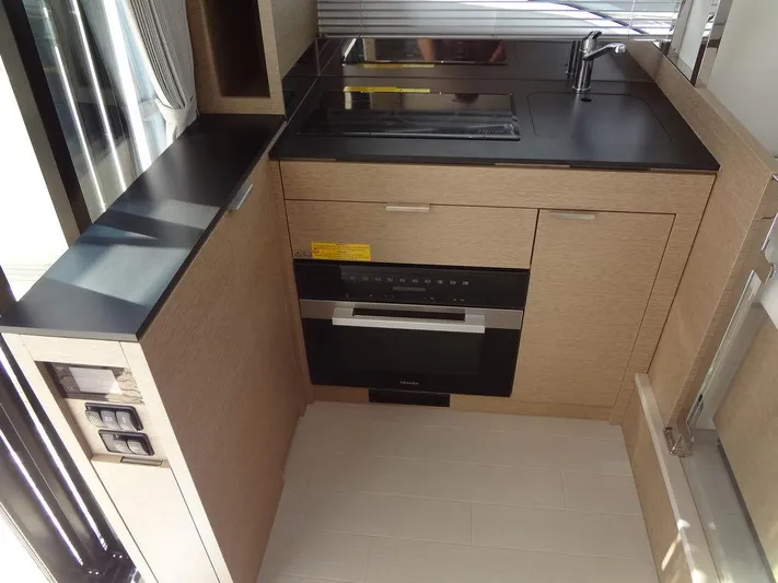  Yacht Photos Pics Modern kitchen in 2024 Prestige 420F RV with sleek cabinetry and built-in appliances.