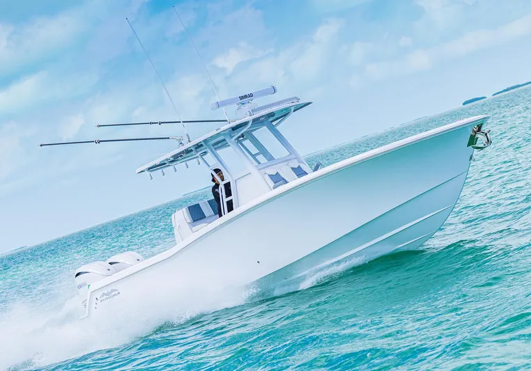  Yacht Photos Pics 2024 Invincible 33 Open Fisherman boat cruising on the ocean.