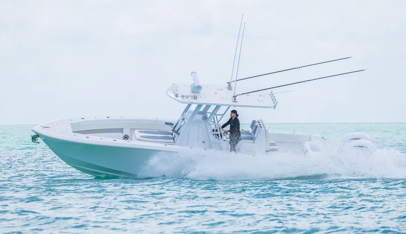  Yacht Photos Pics 2024 Invincible 33 Open Fisherman boat cruising on the ocean.