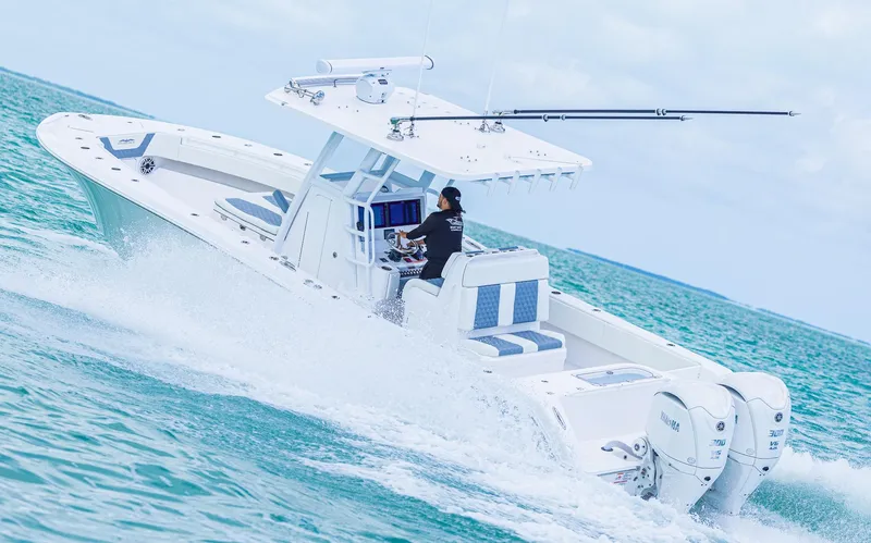  Yacht Photos Pics 2024 Invincible 33 Open Fisherman boat cruising on the ocean.