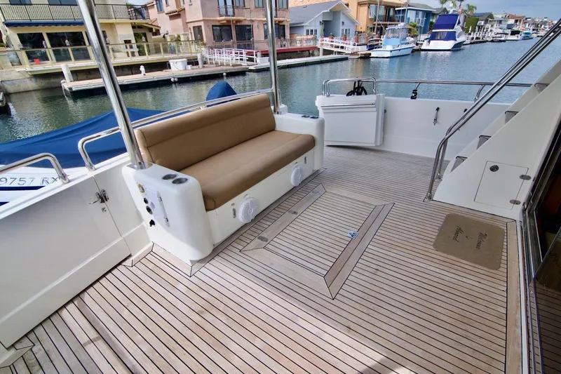 Pangea Yacht Photos Pics 2007 Norseman 560 Sedan yacht deck with seating, docked in a marina.