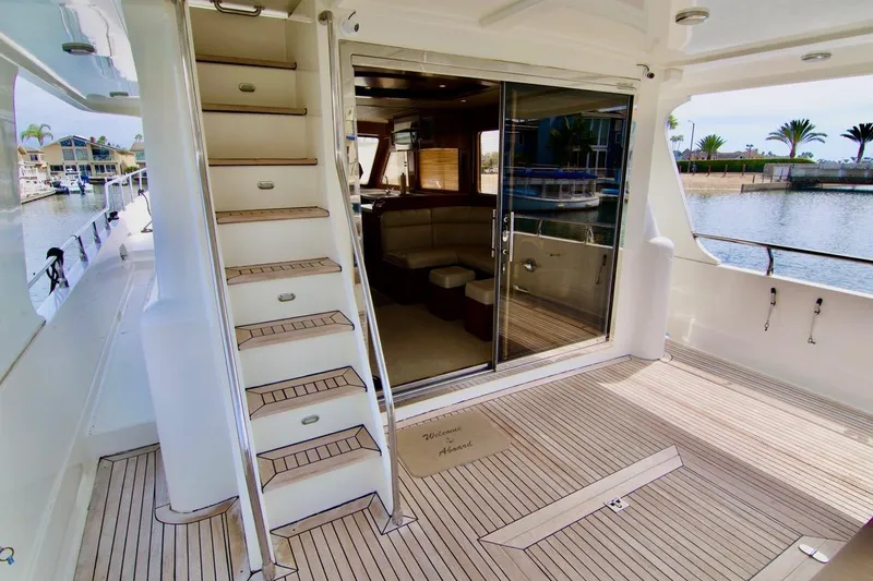 Pangea Yacht Photos Pics Luxurious 2007 Norseman 560 Sedan yacht interior with wooden deck and waterfront view.