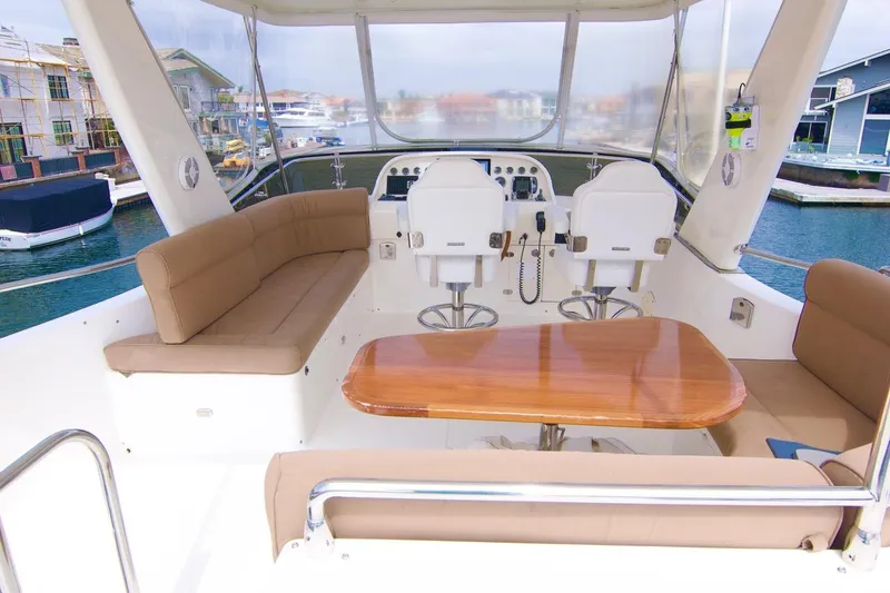 Pangea Yacht Photos Pics Luxurious 2007 Norseman 560 Sedan yacht interior with seating and helm, docked in marina.