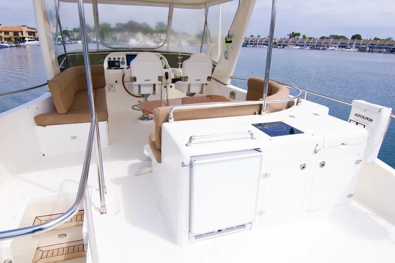 Pangea Yacht Photos Pics 2007 Norseman 560 Sedan yacht interior with seating and helm, overlooking calm waters.