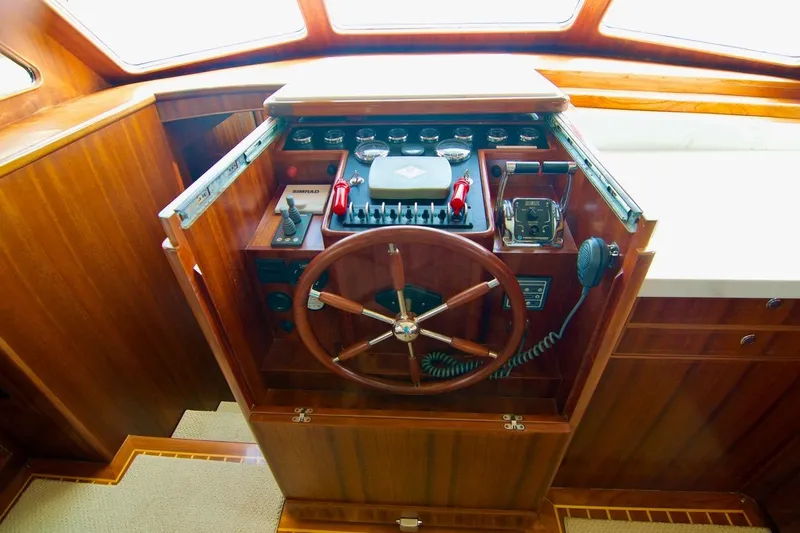 Pangea Yacht Photos Pics 2007 Norseman 560 Sedan yacht helm with wooden steering wheel and navigation controls.