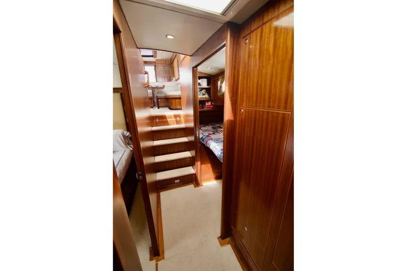 Pangea Yacht Photos Pics Interior of 2007 Norseman 560 Sedan yacht with wooden stairs and cozy cabin.