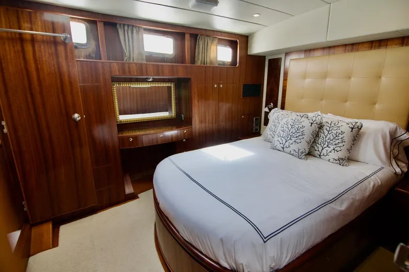 Pangea Yacht Photos Pics Luxurious 2007 Norseman 560 Sedan yacht bedroom with elegant wood paneling and plush bedding.