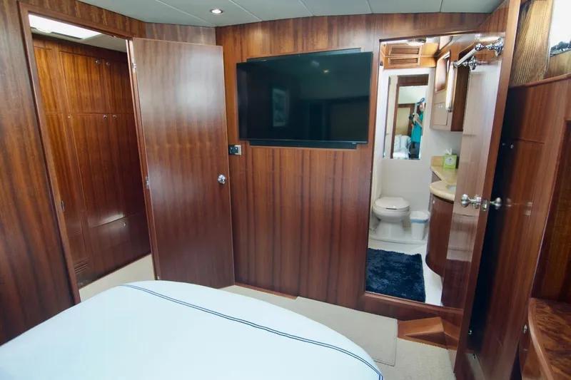 Pangea Yacht Photos Pics Luxurious 2007 Norseman 560 Sedan yacht interior with wood paneling and ensuite bathroom.