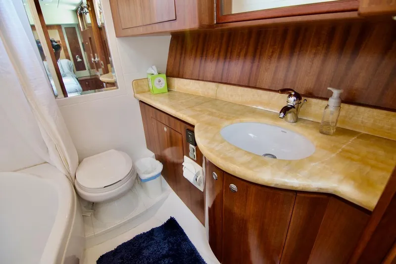 Pangea Yacht Photos Pics Luxurious bathroom in 2007 Norseman 560 Sedan yacht with wood cabinetry and marble countertop.