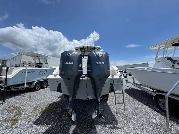  Yacht Photos Pics 2016 Sea Fox 288 Commander with twin 300 horsepower engines, parked on gravel lot.