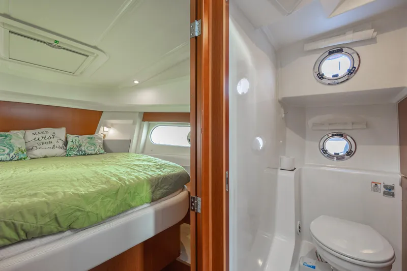 Smooth Yacht Photos Pics 2019 Beneteau Swift Trawler 30 interior with cozy bedroom and compact bathroom.