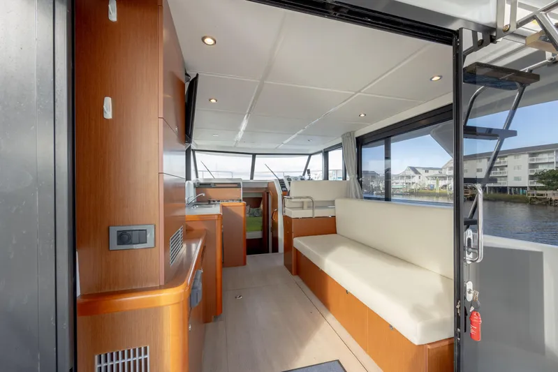 Smooth Yacht Photos Pics Interior of 2019 Beneteau Swift Trawler 30, featuring modern seating and panoramic windows.