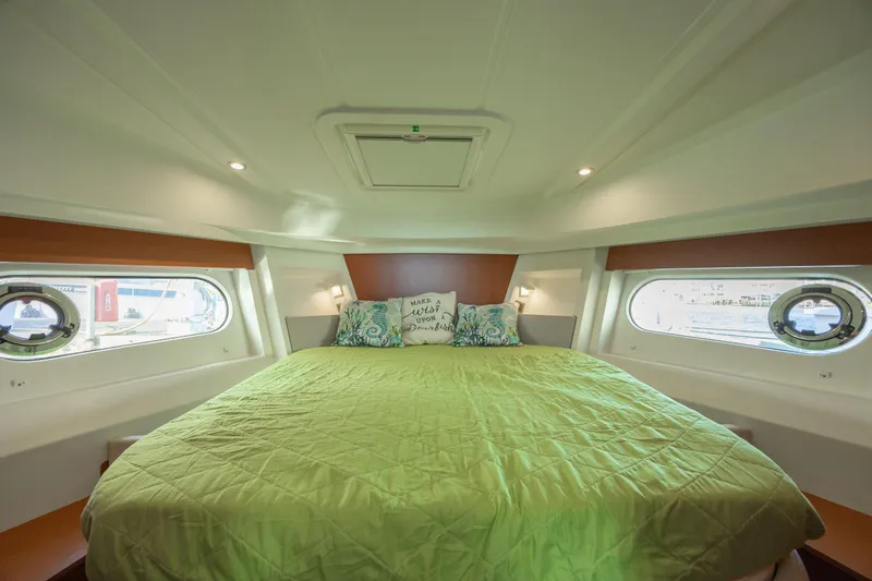 Smooth Yacht Photos Pics Luxurious cabin interior of 2019 Beneteau Swift Trawler 30 with green bedding.