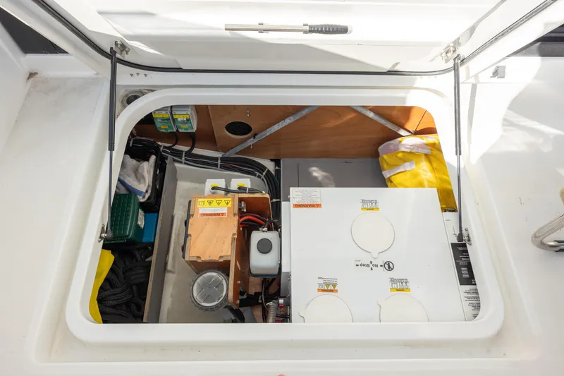 Smooth Yacht Photos Pics 2019 Beneteau Swift Trawler 30 engine compartment with equipment and storage.