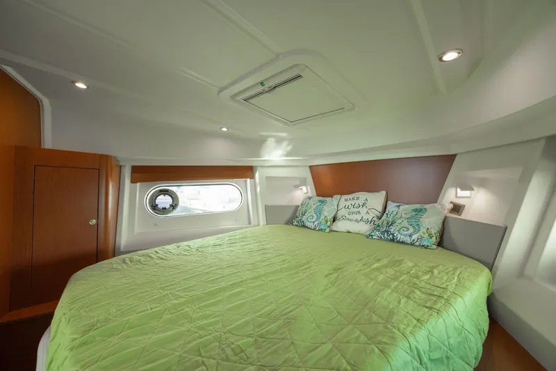 Smooth Yacht Photos Pics Cozy bedroom in 2019 Beneteau Swift Trawler 30 with green bedding and porthole window.