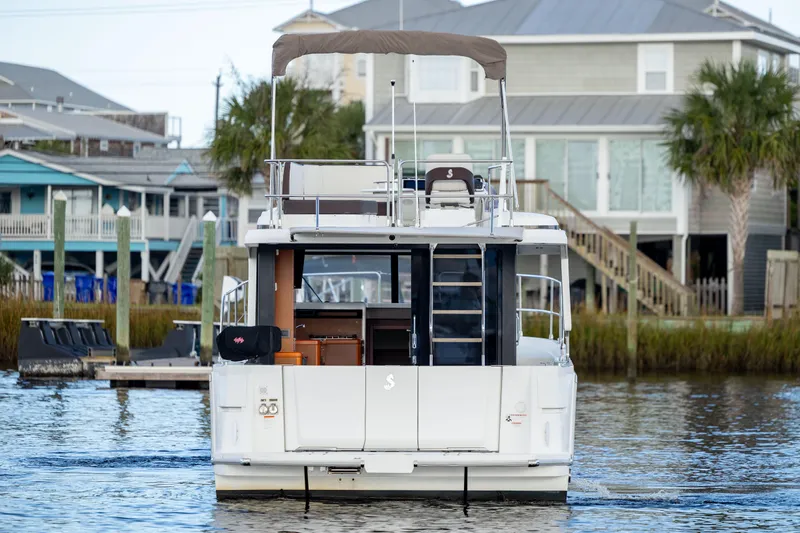 Smooth Yacht Photos Pics 2019 Beneteau Swift Trawler 30 docked near waterfront homes.