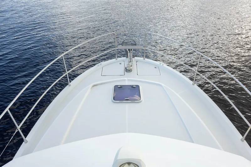 Smooth Yacht Photos Pics 2019 Beneteau Swift Trawler 30 bow view on calm water.