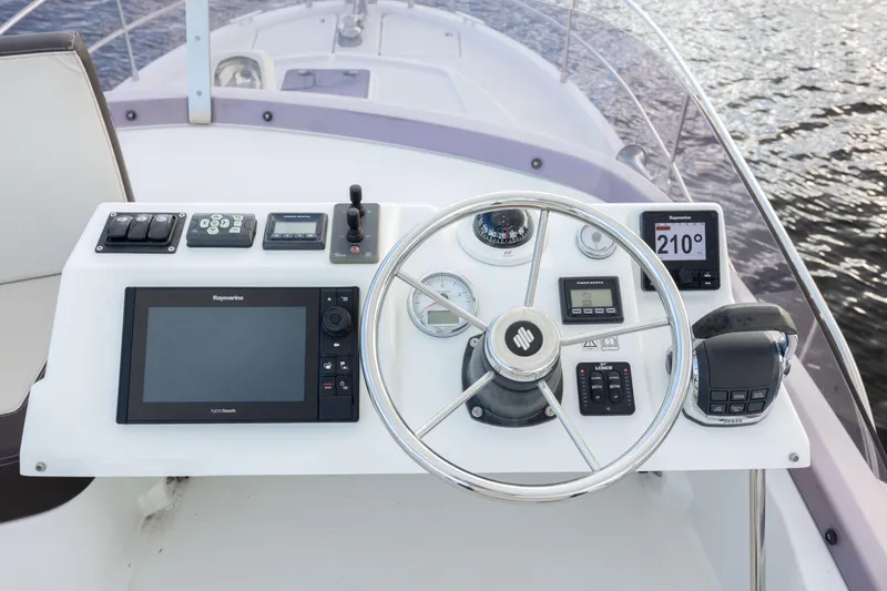 Smooth Yacht Photos Pics 2019 Beneteau Swift Trawler 30 helm with navigation equipment and steering wheel.