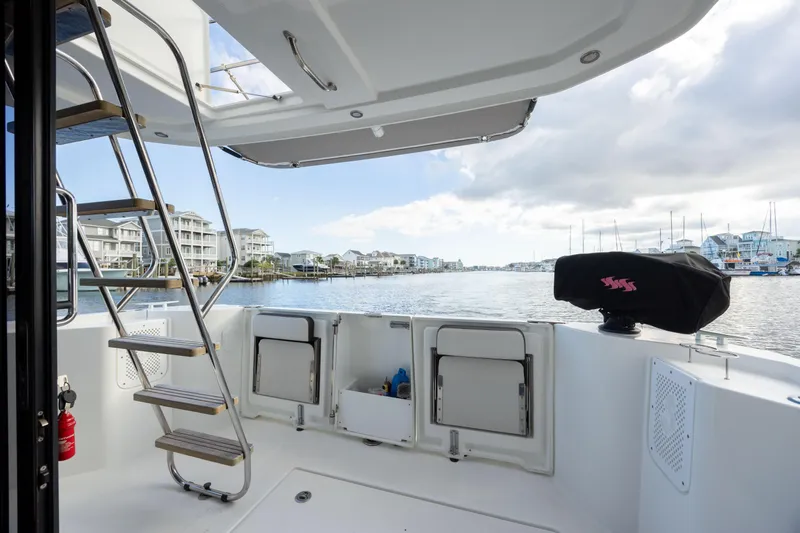 Smooth Yacht Photos Pics 2019 Beneteau Swift Trawler 30 deck view with marina backdrop.