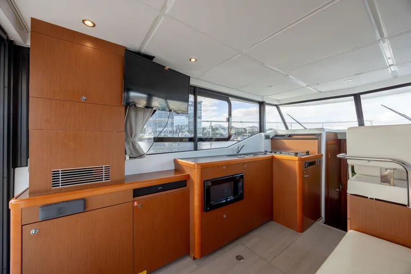 Smooth Yacht Photos Pics Interior of 2019 Beneteau Swift Trawler 30 with modern kitchen and seating area.