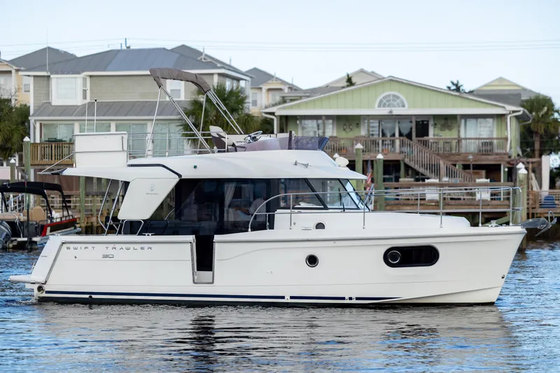 Smooth Yacht Photos Pics 2019 Beneteau Swift Trawler 30 on water near waterfront homes.