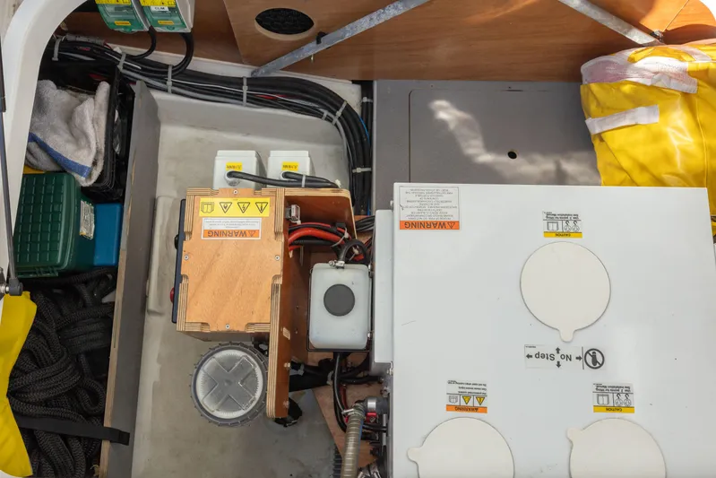 Smooth Yacht Photos Pics Engine compartment of 2019 Beneteau Swift Trawler 30 with electrical components and safety equipment.