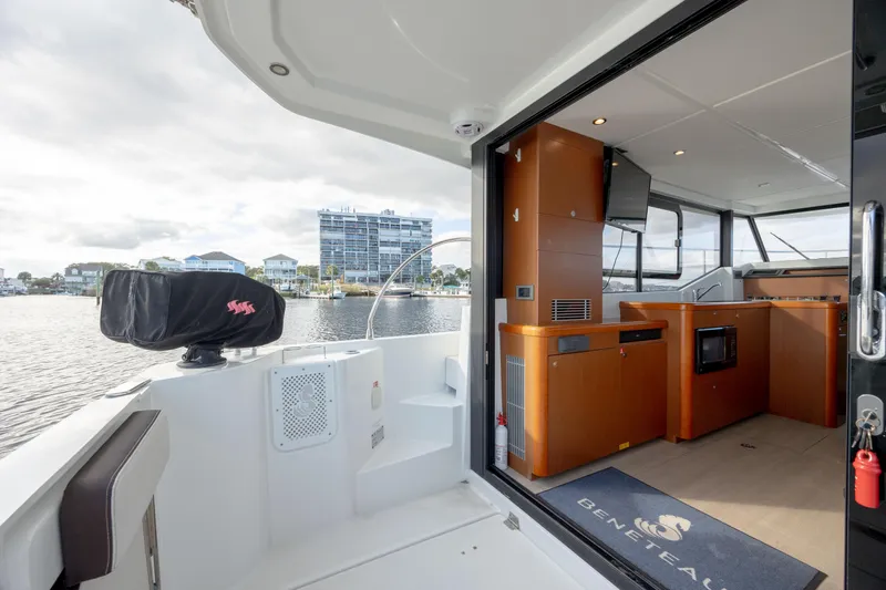 Smooth Yacht Photos Pics 2019 Beneteau Swift Trawler 30 interior with modern kitchen and waterfront view.