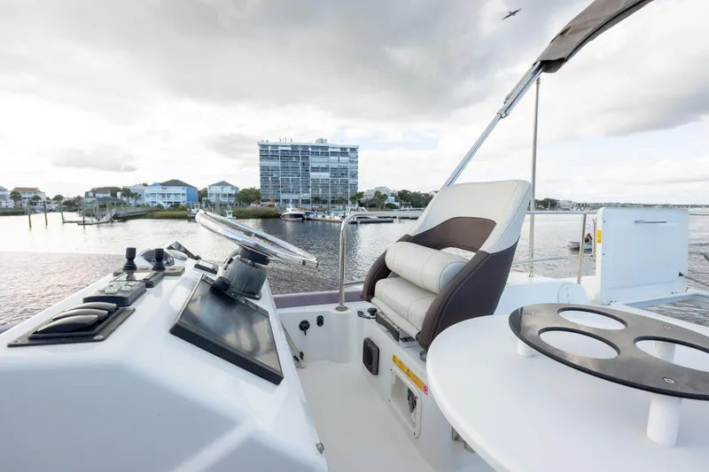 Smooth Yacht Photos Pics 2019 Beneteau Swift Trawler 30 helm with waterfront view and modern controls.