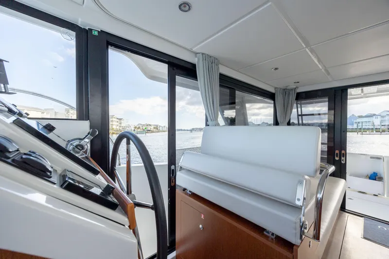 Smooth Yacht Photos Pics Interior of 2019 Beneteau Swift Trawler 30, featuring helm and seating area.