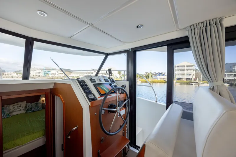 Smooth Yacht Photos Pics Interior of 2019 Beneteau Swift Trawler 30, featuring helm and cabin view.