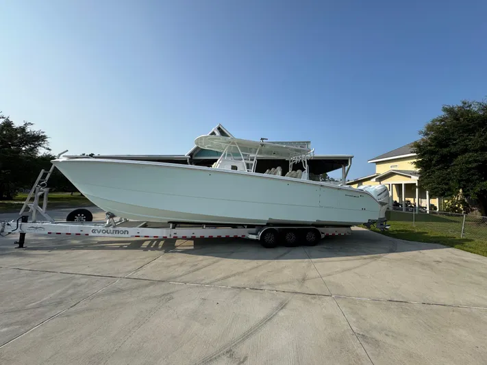  Yacht Photos Pics 2022 Invincible 40 Catamaran on trailer, parked in driveway, sunny day.