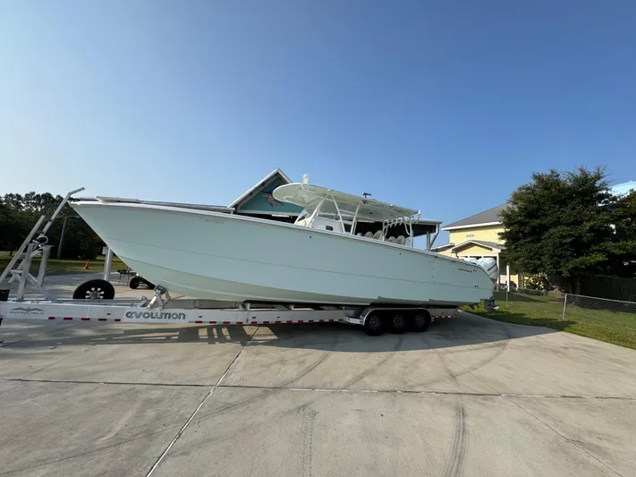  Yacht Photos Pics 2022 Invincible 40 Catamaran on trailer in residential driveway, clear sky background.