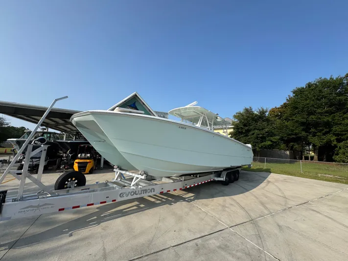  Yacht Photos Pics 2022 Invincible 40 Catamaran on trailer, parked outdoors under clear blue sky.