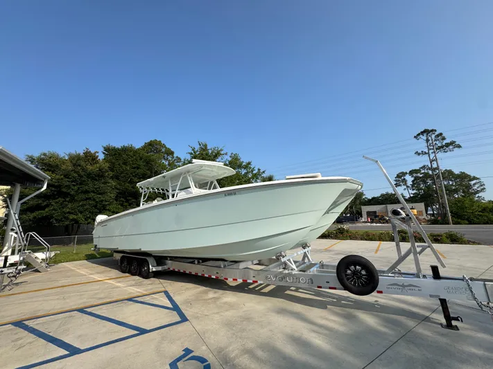  Yacht Photos Pics 2022 Invincible 40 Catamaran on trailer, parked outdoors under clear blue sky.