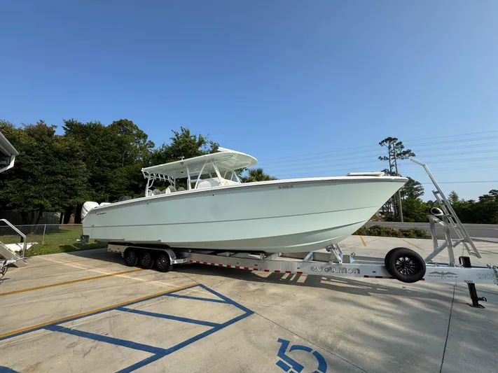  Yacht Photos Pics 2022 Invincible 40 Catamaran on trailer, parked outdoors under clear sky.